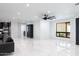 Spacious living area showcasing modern design, sleek flooring, and seamless integration with other rooms at 1861 W Navarro Ave, Mesa, AZ 85202