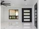 Bright and open living area featuring sleek flooring, modern doors, and ample natural light at 1861 W Navarro Ave, Mesa, AZ 85202