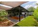 Expansive outdoor space with stylish pergola, hot tub, and lush turf invites entertainment at 1861 W Navarro Ave, Mesa, AZ 85202