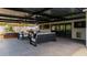 Stylish outdoor living featuring a comfortable seating area, hot tub, and pool table, perfect for gatherings at 1861 W Navarro Ave, Mesa, AZ 85202
