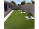 Spacious artificial grass backyard with palm trees at 20443 N 97Th Ave, Peoria, AZ 85382