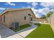 Landscaped backyard with artificial turf, a patio cover, and barbecue, perfect for outdoor activities at 20443 N 97Th Ave, Peoria, AZ 85382