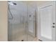 Contemporary glass-enclosed shower with tiled walls and a built-in bench, next to door to patio at 20443 N 97Th Ave, Peoria, AZ 85382