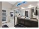 Bright bathroom featuring double vessel sinks, granite counters, and a separate tub and shower at 20443 N 97Th Ave, Peoria, AZ 85382