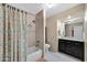 Well-lit bathroom with a shower and tub combination, plus a vanity with granite countertop at 20443 N 97Th Ave, Peoria, AZ 85382