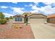 Charming single-story home featuring a low-maintenance desert landscape and a two-car garage at 20443 N 97Th Ave, Peoria, AZ 85382