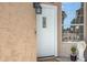 Close-up of the front door with decorative details and textured exterior wall at 20443 N 97Th Ave, Peoria, AZ 85382