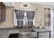 Close up on the stainless steel sink and gray granite countertops at 20443 N 97Th Ave, Peoria, AZ 85382