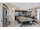 Spacious kitchen features dark cabinets, stainless appliances, and large granite island with bar seating at 20443 N 97Th Ave, Peoria, AZ 85382