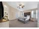 Comfortable main bedroom features neutral tones, ceiling fan, and an arched entry to main bath at 20443 N 97Th Ave, Peoria, AZ 85382