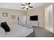 Neutral main bedroom with ceiling fan, gray furniture, and ensuite bathroom entrance at 20443 N 97Th Ave, Peoria, AZ 85382