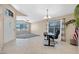Open office space with abundant natural light, neutral tones, and a view into the living room at 20443 N 97Th Ave, Peoria, AZ 85382