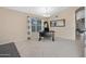 Bright home office with neutral walls, tile floors, and a contemporary chandelier at 20443 N 97Th Ave, Peoria, AZ 85382