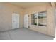 Covered patio with multiple doors, offering a shaded outdoor living space at 20443 N 97Th Ave, Peoria, AZ 85382
