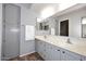 Bright bathroom boasts double sinks with a large mirror, updated lighting, and ample cabinet space at 205 N 74Th St # 248, Mesa, AZ 85207