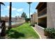 Well maintained grassy area near a fenced-in community pool at this condo community at 205 N 74Th St # 248, Mesa, AZ 85207