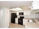 Efficient kitchen features modern, black appliances, white cabinetry and updated lighting at 205 N 74Th St # 248, Mesa, AZ 85207
