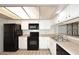 Bright kitchen with white cabinetry and black appliances for a clean, modern feel at 205 N 74Th St # 248, Mesa, AZ 85207