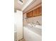 Handy laundry room shows side by side washer and dryer with upper cabinets and a small shelf at 205 N 74Th St # 248, Mesa, AZ 85207