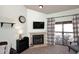 Comfortable living room with fireplace and access to a balcony that overlooks community landscape at 205 N 74Th St # 248, Mesa, AZ 85207