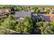 Aerial view of a home with a gray roof, lush greenery, and a well-manicured lawn at 20866 W Werner Pl, Buckeye, AZ 85396