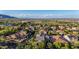 Expansive aerial view of the neighborhood showcasing lush greenery and stunning mountain views in the distance at 20866 W Werner Pl, Buckeye, AZ 85396