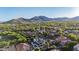 Aerial view of community nestled against the mountain with lush landscaping at 20866 W Werner Pl, Buckeye, AZ 85396