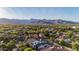 Picturesque aerial view of the neighborhood with mountain views and lush greenery at 20866 W Werner Pl, Buckeye, AZ 85396
