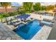 Aerial view of a backyard featuring a luxurious pool, spa, patio, and outdoor lounge area at 20866 W Werner Pl, Buckeye, AZ 85396