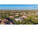 Wide aerial view of the property showing its location within a well-established neighborhood with lush trees and rooftops at 20866 W Werner Pl, Buckeye, AZ 85396