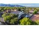 An aerial view of a luxurious home surrounded by trees, showcasing the expansive backyard and scenic mountain views at 20866 W Werner Pl, Buckeye, AZ 85396