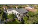 Aerial view of a two-story home with manicured lawn and landscaping, showing the balcony and backyard at 20866 W Werner Pl, Buckeye, AZ 85396