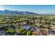 Scenic aerial shot of the community featuring lush greenery and majestic mountains in the backdrop at 20866 W Werner Pl, Buckeye, AZ 85396