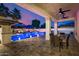 Inviting backyard featuring a pool, covered dining area, and luxurious outdoor lounge at 20866 W Werner Pl, Buckeye, AZ 85396