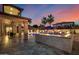 Expansive backyard showcasing a pool, covered patio, and lush landscaping at dusk at 20866 W Werner Pl, Buckeye, AZ 85396