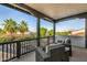 Balcony showcasing wicker furniture, wooden railings, and a view of the neighborhood at 20866 W Werner Pl, Buckeye, AZ 85396