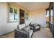 Balcony with outdoor seating and a view into an interior room with a television at 20866 W Werner Pl, Buckeye, AZ 85396