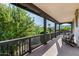 The exterior balcony with chairs has a wooden railing and concrete flooring at 20866 W Werner Pl, Buckeye, AZ 85396