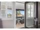 Balcony view with a seating area, palm trees, and glimpses of nearby homes at 20866 W Werner Pl, Buckeye, AZ 85396