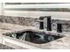 A stylish bathroom sink with sleek fixtures and granite countertops at 20866 W Werner Pl, Buckeye, AZ 85396