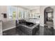 Elegant bathroom with a black soaking tub, dual vanities, and marble flooring at 20866 W Werner Pl, Buckeye, AZ 85396