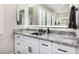 Close-up of a bathroom vanity featuring granite countertops, sleek fixtures, and ample storage at 20866 W Werner Pl, Buckeye, AZ 85396