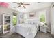 The bedroom has an exterior balcony, gray carpeting, and natural light coming from a set of windows at 20866 W Werner Pl, Buckeye, AZ 85396
