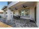 Charming covered patio with ceiling fans, dining area, and stylish stone flooring at 20866 W Werner Pl, Buckeye, AZ 85396