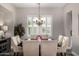 Elegant dining room featuring a chandelier, and a window with shutters at 20866 W Werner Pl, Buckeye, AZ 85396