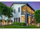 Elegant two-story home with a second-story balcony, lush landscaping, and manicured lawn at 20866 W Werner Pl, Buckeye, AZ 85396