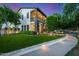 Elegant home featuring a well-kept lawn, stone accents, and lush landscaping at 20866 W Werner Pl, Buckeye, AZ 85396