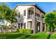 Charming two-story home showcasing manicured landscaping, a balcony, and stone pillars at 20866 W Werner Pl, Buckeye, AZ 85396