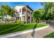 Two-story home with a well-manicured lawn, balcony, stone pillars, and verdant trees at 20866 W Werner Pl, Buckeye, AZ 85396