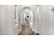 Elegant hallway with arched doorways and wood flooring at 20866 W Werner Pl, Buckeye, AZ 85396